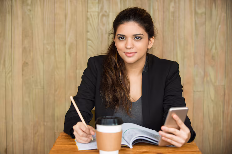 smiling-female-student-doing-homework-desk_1262-5768